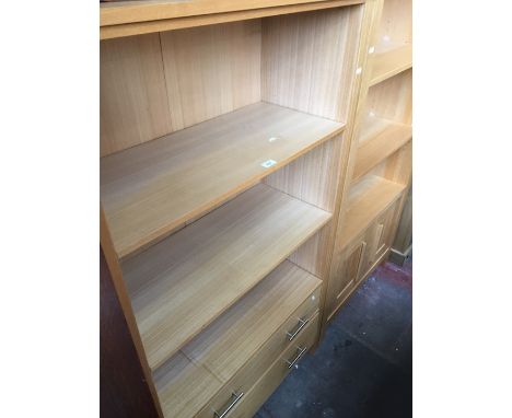 A light wood effect bookcase with two lower drawers. 