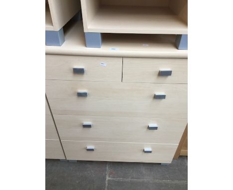 A modern light wood chest of drawers. 