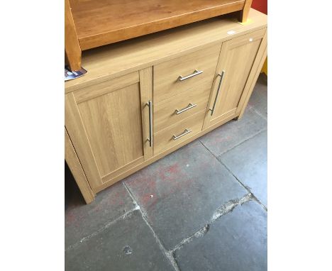 A modern light wood effect sideboard. 