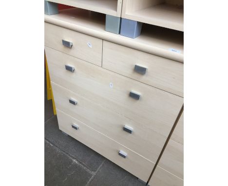 A modern light wood chest of drawers. 