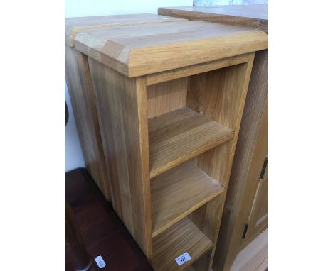 A pair of light oak CD racks. 