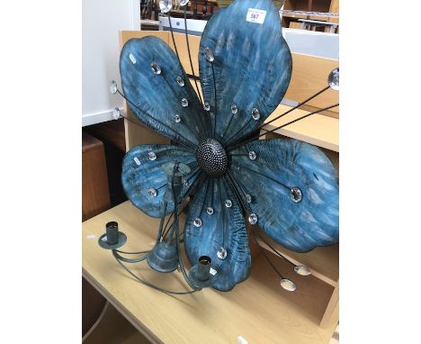 A wall art tin flower ornament and a central light fitting in vintage style. 