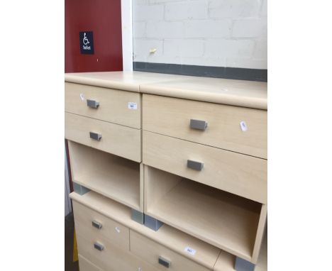 A pair of modern light wood effect bedside cabinets. 