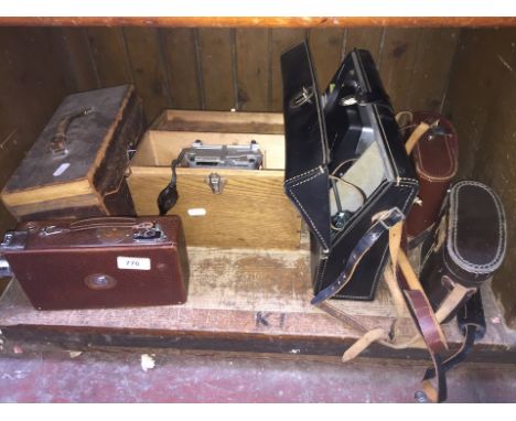 Vintage cine camera and lamp, two pairs binoculars and a Polaroid camera 