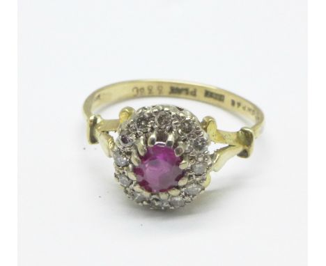 An 18ct gold and platinum set, ruby and diamond cluster ring, 3.4g, P