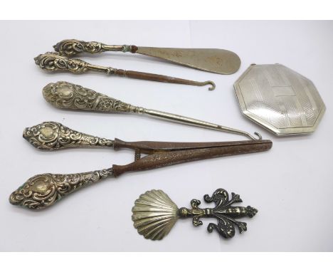 A silver powder compact caddy spoon and five silver handled button hooks