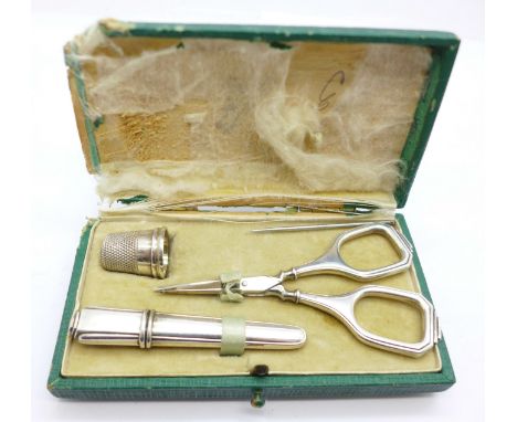 A silver sewing compendium, comprising silver scissors, a thimble and needle case, boxed