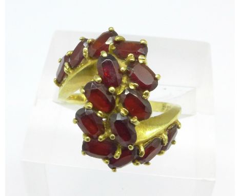 A yellow metal (tests as 18ct gold) and garnet ring, 6.2g, L