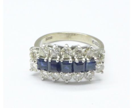 An 18ct white gold, diamond and sapphire ring, set with fourteen brilliant cut diamonds and five square sapphires, 4.3g, J