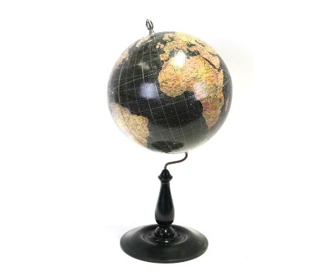 A decorative world globe on a turned ebonised wooden stand, 59cm (23.25ins) high 