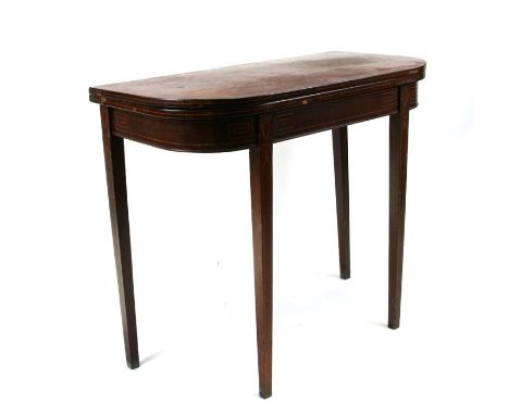 An early 19th century mahogany fold-over card table with square tapering legs, 89cm (35ins) wide. 