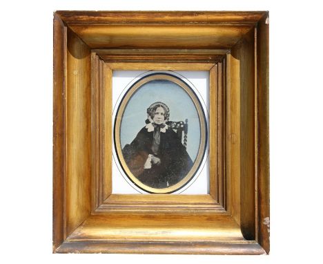 A large Victorian ambrotype of an old lady, mounted in a heavy gilt frame, 17 by 20cms (6.25 by 8ins).