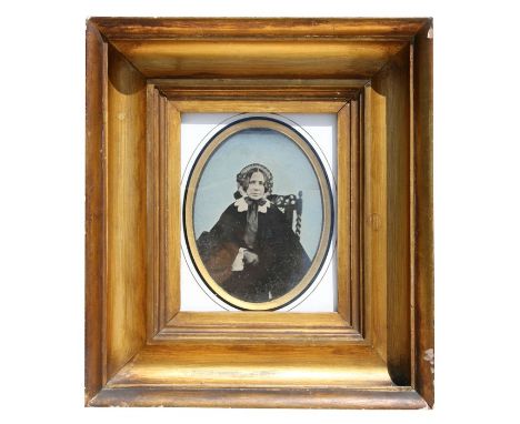 A large Victorian ambrotype of an old lady, mounted in a heavy gilt frame, 17 by 20cms (6.25 by 8ins).