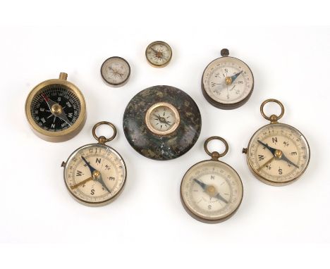 A group of compasses to include escape compasses and a Cornish Serpentine desk compass, 