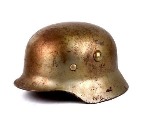 A post WW2 German steel helmet with turned under edge. Complete with leather liner marked M-1943 and chin strapCondition Repo