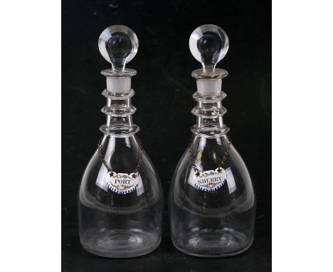 A pair of Georgian glass decanters of small proportions; together with enamel Port and Sherry bottle labels, the decanters 23