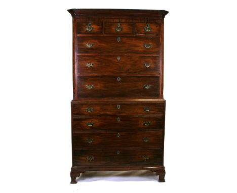 A George III figured mahogany chest on chest with three short and three long drawers above four graduated long drawers, on br