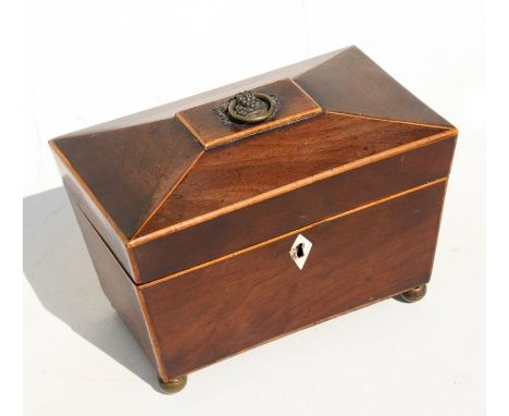 An early 19th century mahogany two-division sarcophagus tea caddy, 20cm (8ins) wide. Condition Reportgeneral wear commensurat