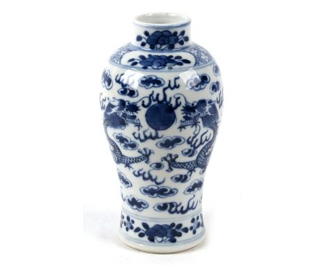 A Chinese blue and white vase decorated dragons chasing a flaming pearl amongst clouds, 17cm (6.75ins) high Condition Reportg