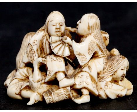 A 19th century Japanese ivory netsuke depicting a group of women holding fans, two character mark to the underside, 4cms (1.5