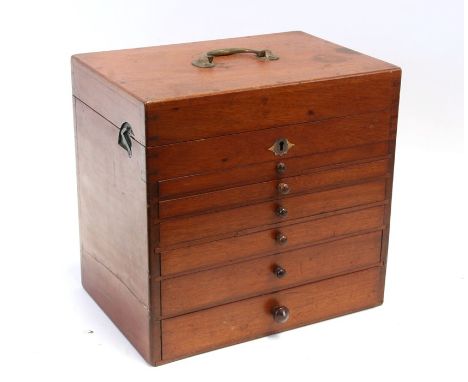 A late 19th / early 20th century mahogany dentist's cabinet with lift up lid containing a sectioned interior above six long g