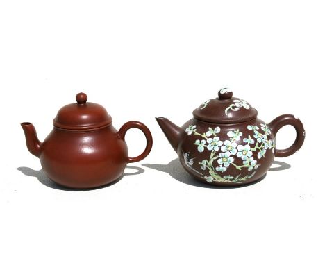 A Chinese Yixing miniature pottery teapot, 7.5cms (3ins) high; together with another similar with enamel decoration (2).Condi