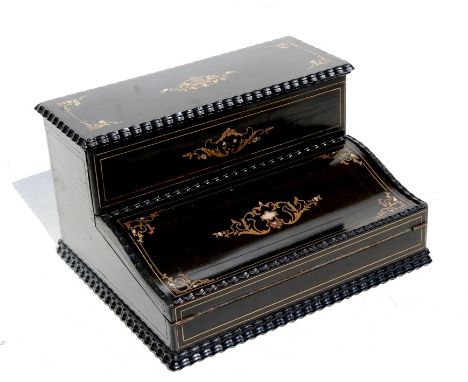 A 19th century French ebonised writing box with stationary compartment and writing slope, inlaid with brass and mother of pea