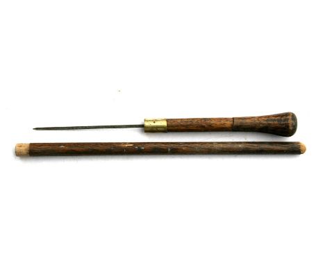 A wooden swagger stick with concealed dagger. The dagger is 14cms (5.5ins) long with the overall length being 53.5cms (21ins)