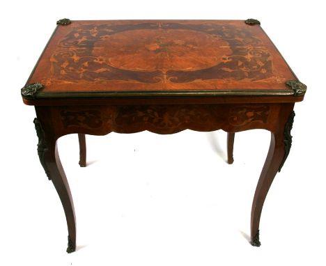 A French marquetry inlaid ormolu mounted fold-over card table, 81cms (32ins) wide.