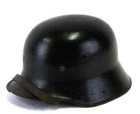 An M16 Imperial German helmet with liner and chin strap. 