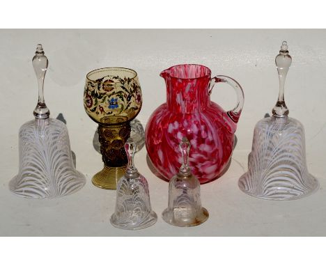 Two pairs of large and small Nailsea style glass table bells, the largest 26cm (10ins) high; together with an Art glass jug a