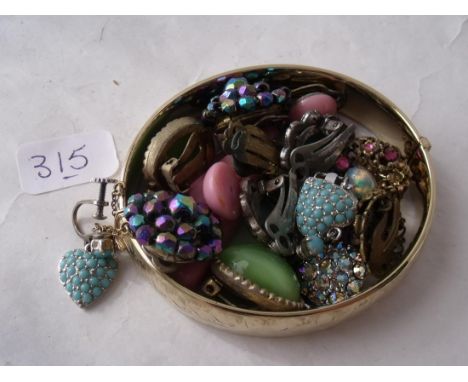 A rolled gold bangle also a quantity  of vintage paste clip on earrings     