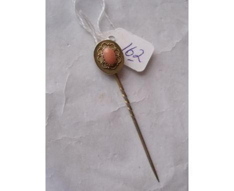 An ornate gold mounted coral stick pin 2.3g    