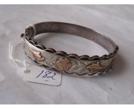 A silver hinged bangle with 9ct  leaf & flower decoration  24g     