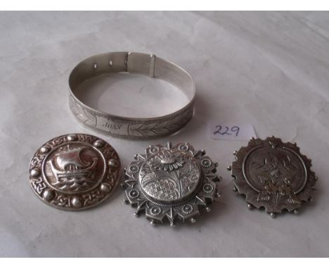 Three silver brooches and a bangle 42g    