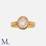An Antique Pink Topaz Ring in 18K yellow gold. Set with an oval-cut pink topaz to a beaded setting