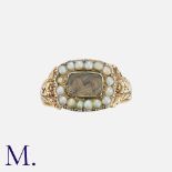 A Georgian Mourning Ring in yellow gold, with locket to the front and pearls in surround.