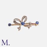 An Antique Sapphire and Diamond Brooch in yellow gold and silver, in the form of a bow, set with