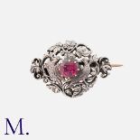 An Art Nouveau Brooch in silver, set with a principal ruby of approximately 1.00cts, within an