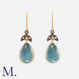 A Pair Of Topaz And Diamond Earrings in silver and 9k yellow gold, each comprising a floral, rose