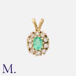 An Emerald and Diamond Pendant in 9K gold, set with an oval cut emerald to the centre with ten round