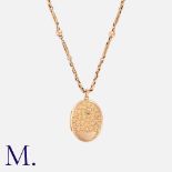 An Antique Gold Locket And Chain in 9k yellow gold, the foliate and scrolling engraved locket