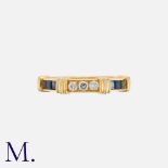 CARTIER. A Diamond and Sapphire Ring in 18K set with three round brilliant diamonds and six square