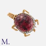 A French Garnet And Diamond Novelty Tortoise Brooch in 18k yellow gold, comprising a carved cabochon