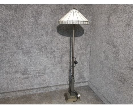 A Tiffany style standard lamp with cream shade.