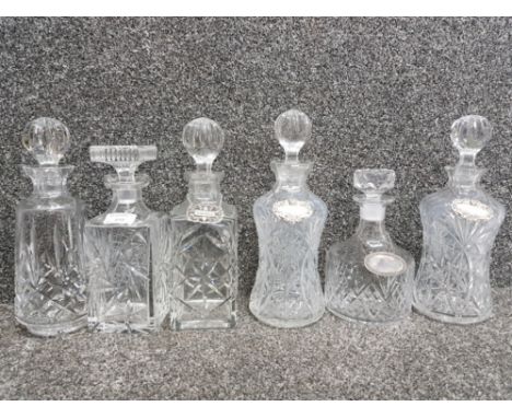 Six cut glass decanters and four labels whisky, gin, vodka and brandy.