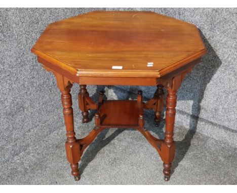 A late 19th/early 20th century octagonal centre table raised on ceramic castors 77cm diameter