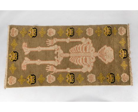 Tibet carpet, skeleton with faces and skull heads on light brown ground, textile woven, with side strings. 172X88cm