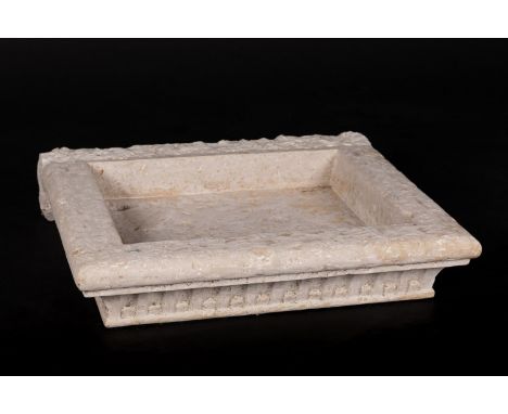 Renaissance stone basin in quadratic shape with three curved sides and fluted, sculpted ornaments on white chalk stone. On th