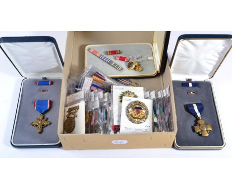 A US Navy and Marine Corps Navy Cross Medal, with ribbon bar and enamel lapel pin in Arrow presentation case; a US Army Disti